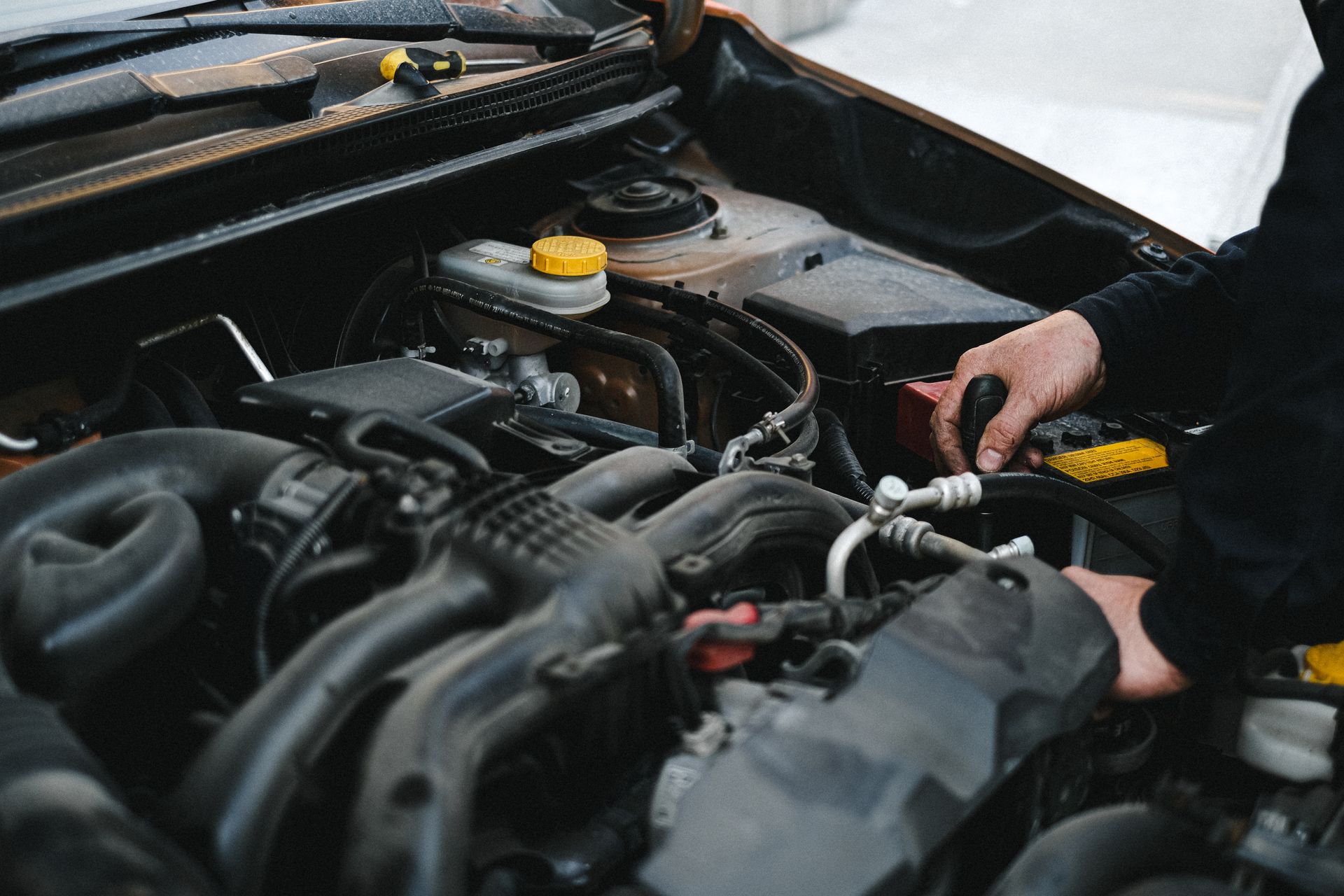 A mechanic working on a vehicle engine